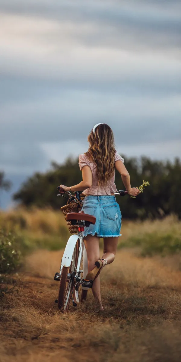 woman holding white and brown bike wallpaper