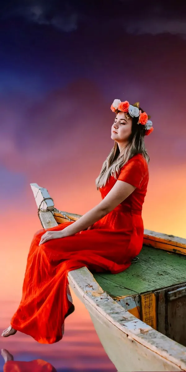 woman in red dress sitting on white wooden boat wallpaper