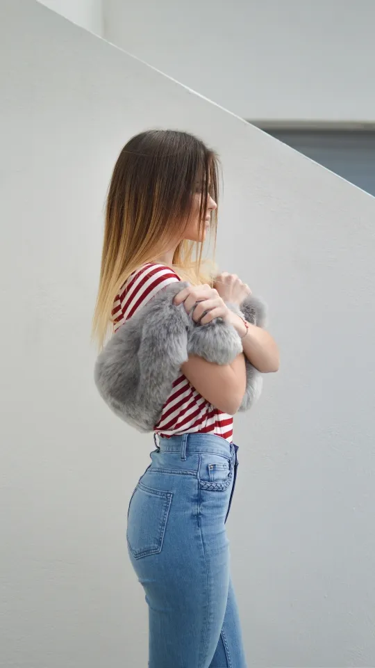 woman with pink fur scarf near wall wallpaper