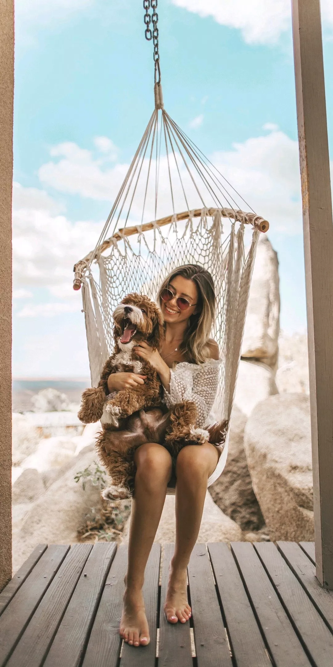 woman sitting on hammock with plush toy wallpaper